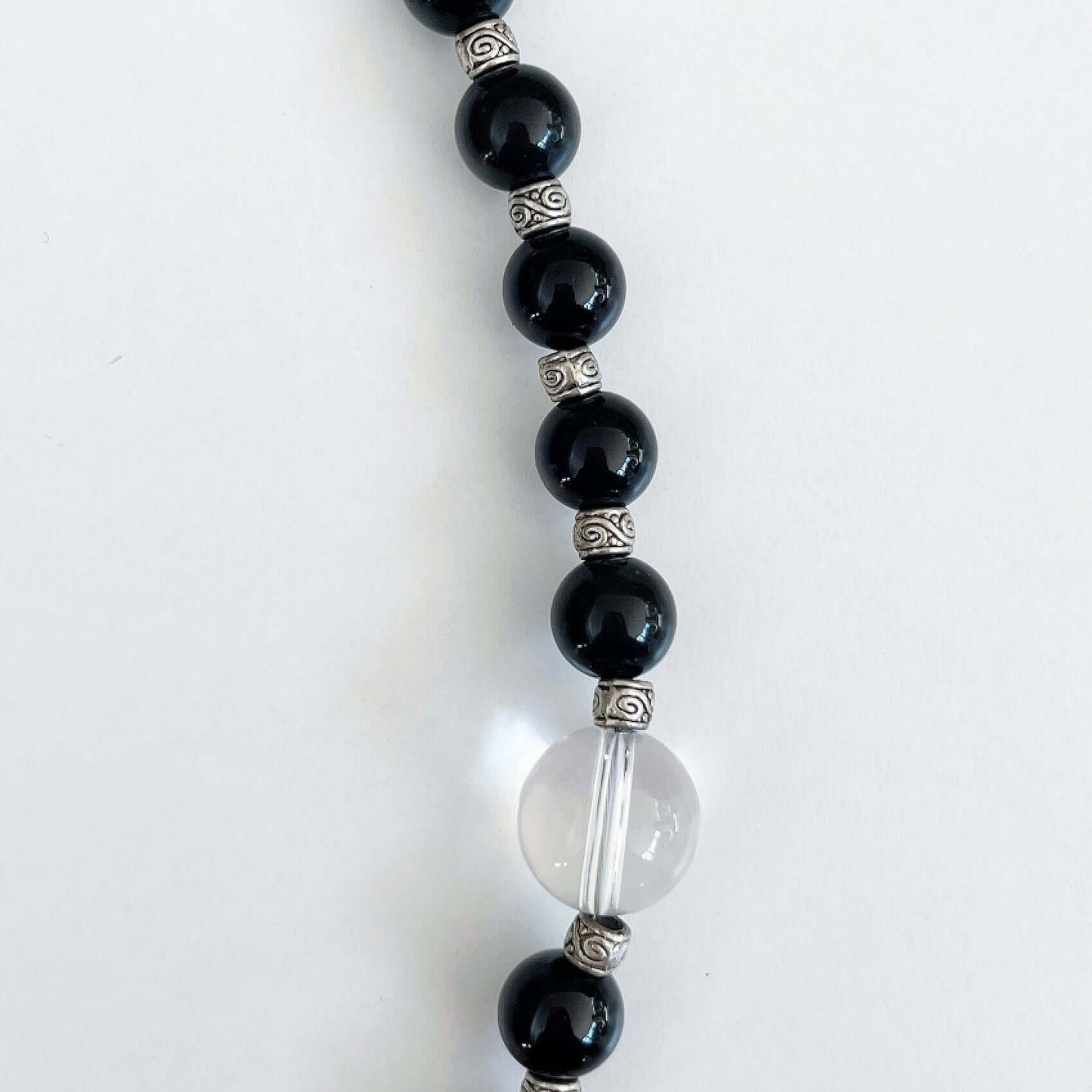 Detail view of the actual Obsidian and clear quartz beads, the latter is a slightly bigger size.