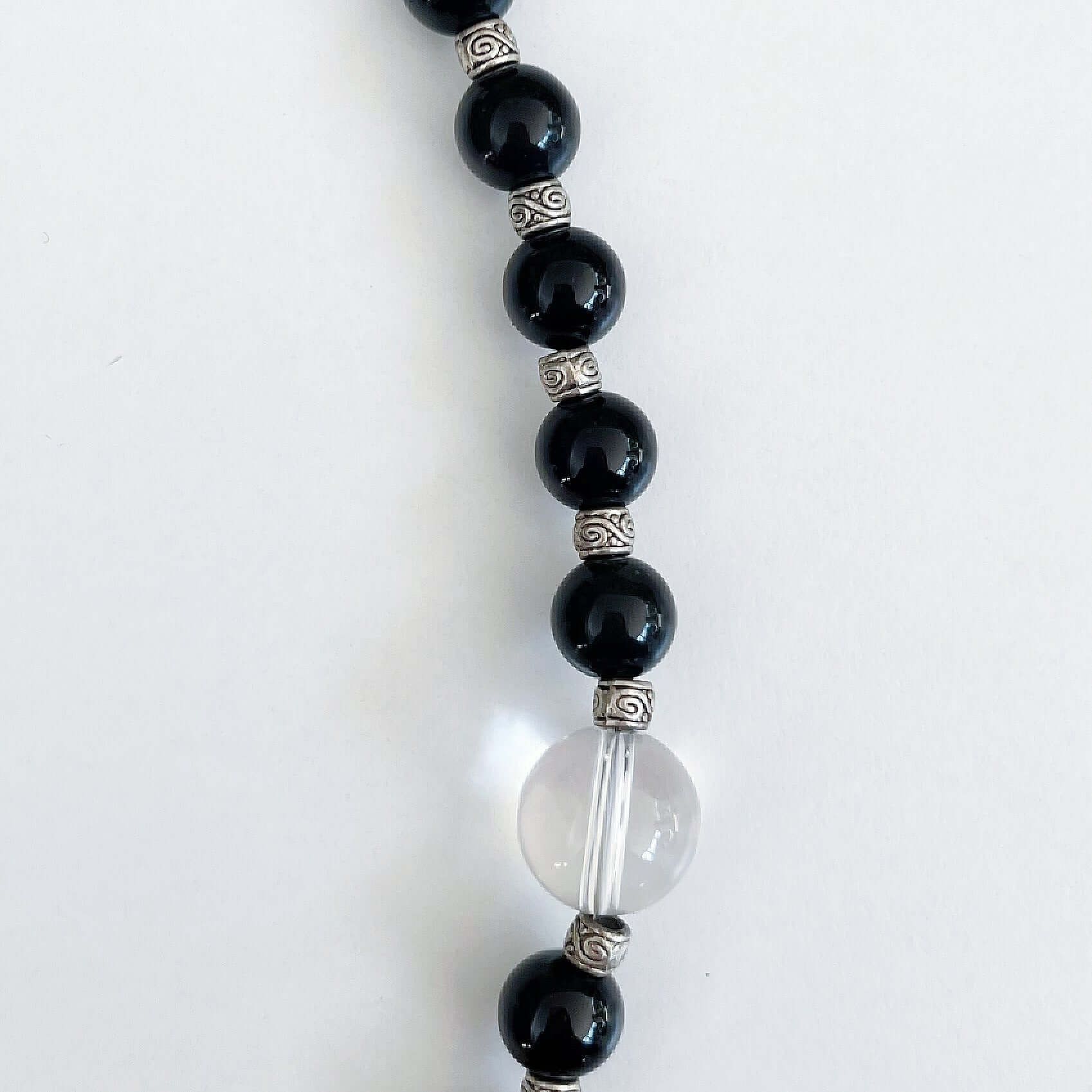 Detail view of the actual Obsidian and clear quartz beads, the latter is a slightly bigger size.
