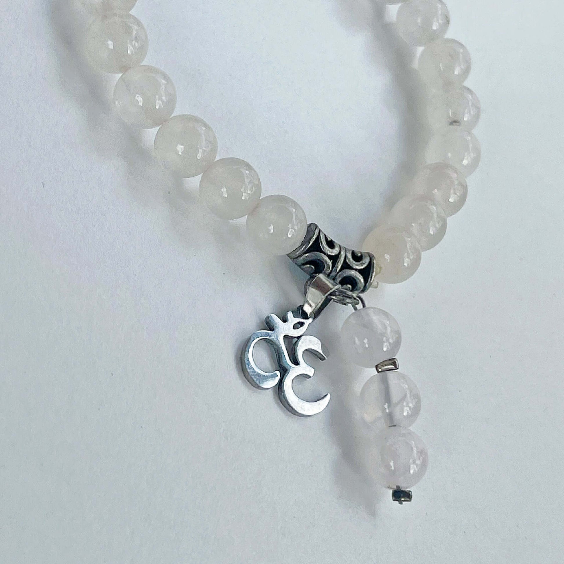 Detail view of the bracelet, with Om Sign and 3-bead dangle.