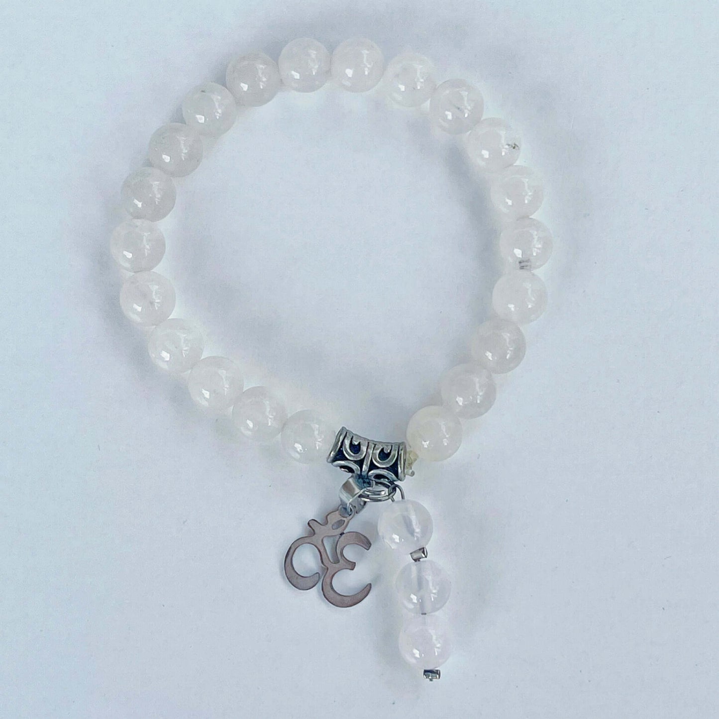 Top view of beaded bracelet with matching 3 bead dangle and Om Sign attached to silver bead.