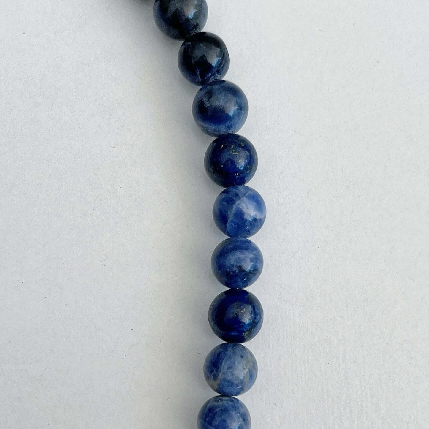 Detail view of necklace showing the beads with their deep blue and off-white striations.