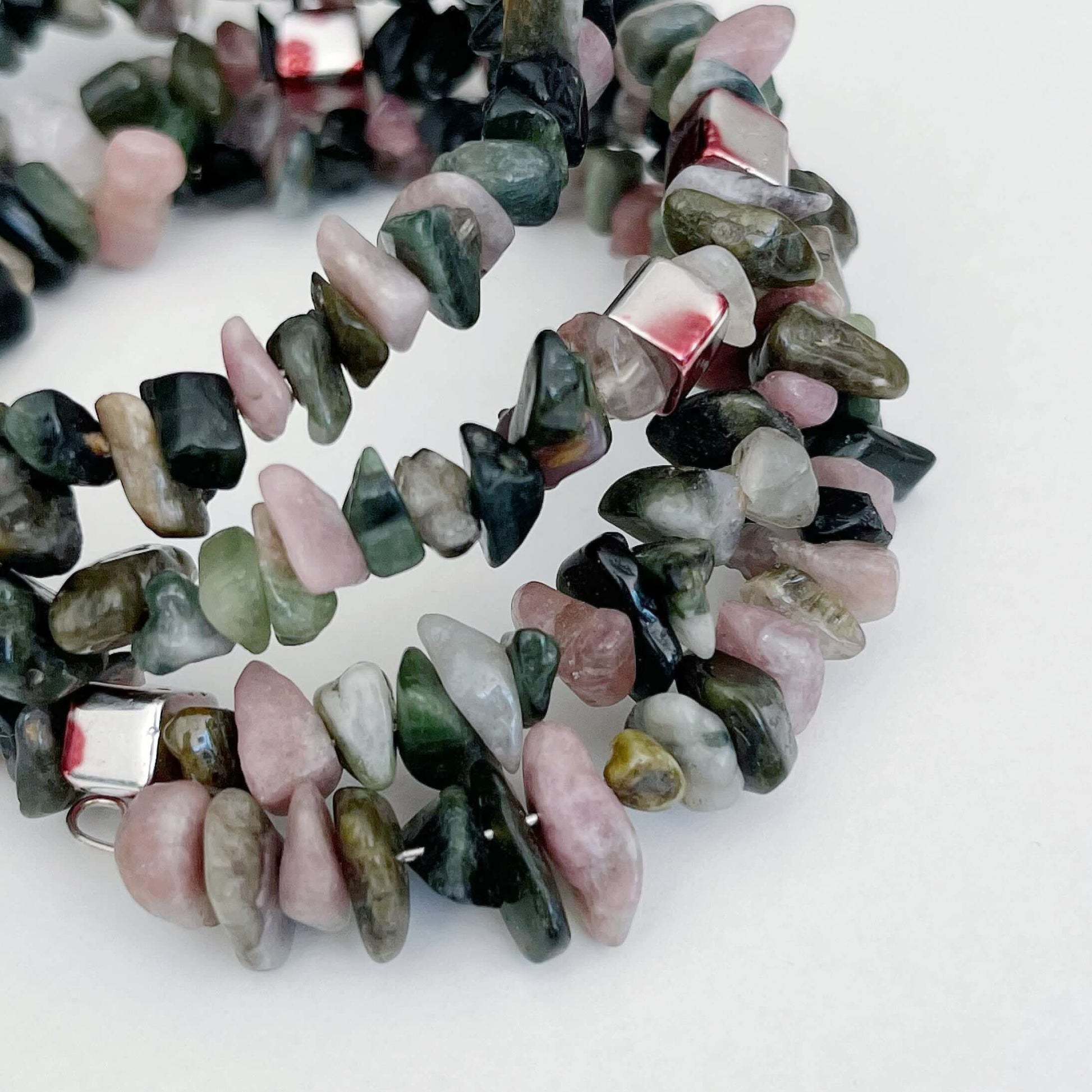 Detail view of bracelet, in a gorgeous mixture of differing shades of green and pink tumbled Tourmaline chips.