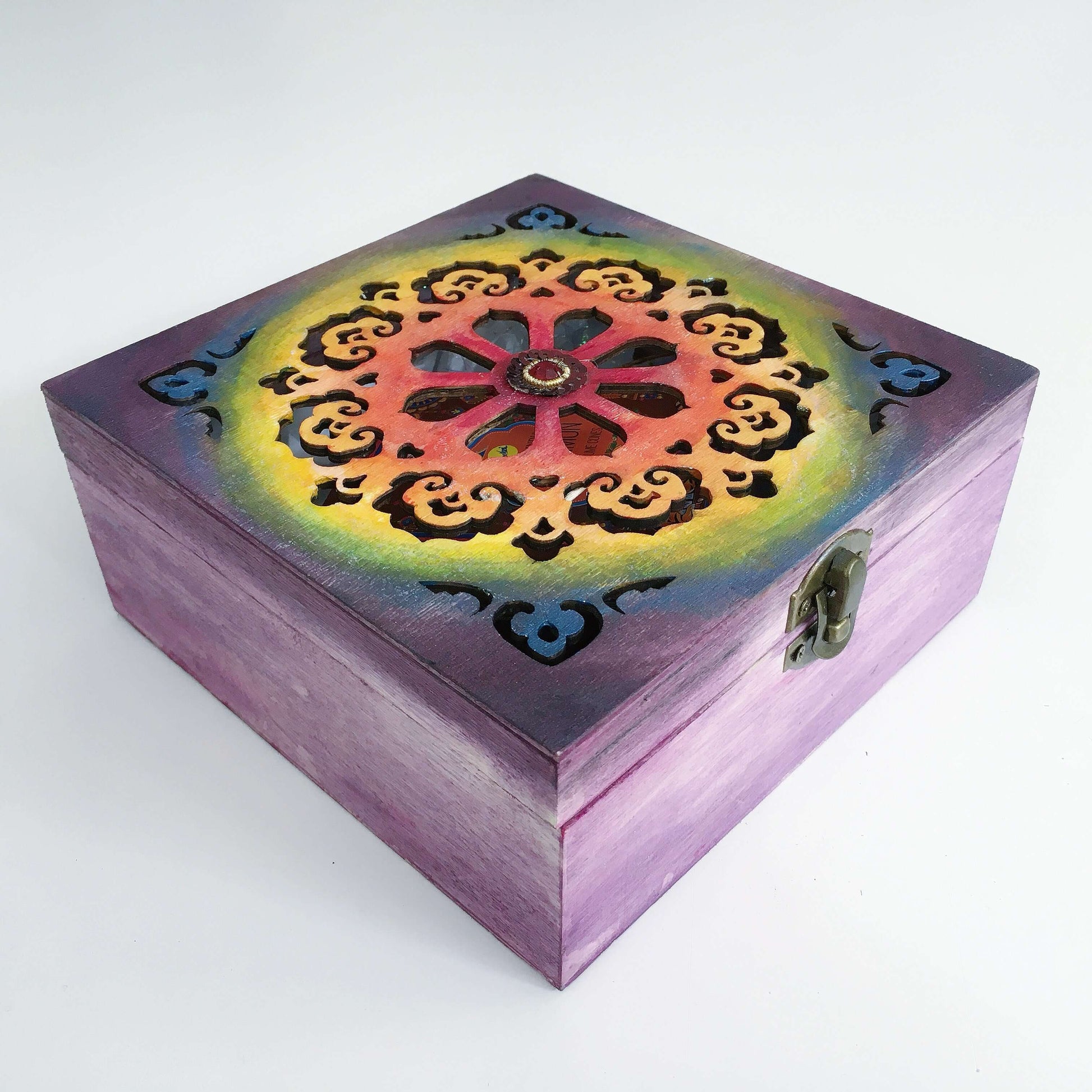 Outside view painted purple box, blending into rainbow shades on laser-cut lid, in ornate circular pattern, metal clasp.