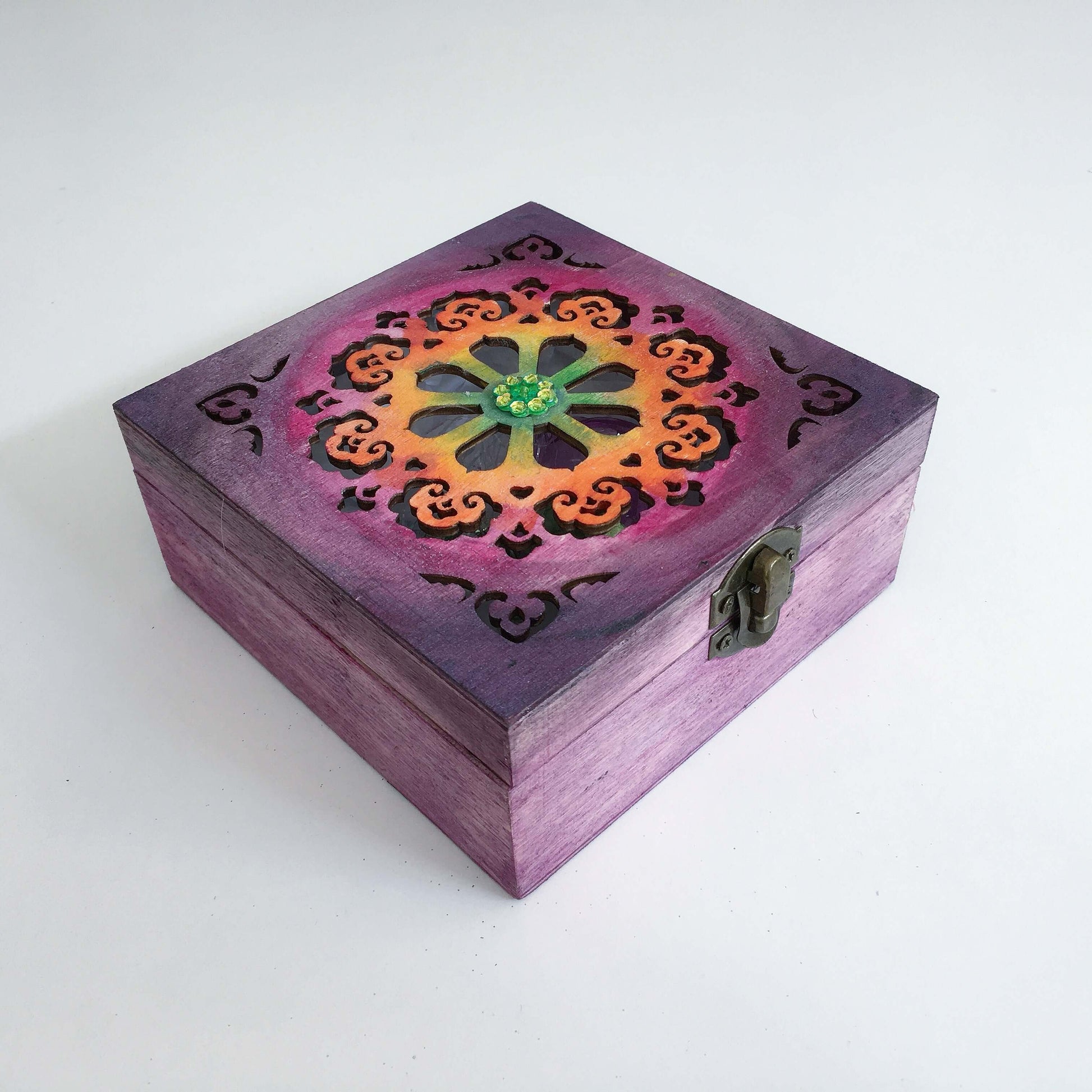 Outside view painted purple box, blending into rainbow shades on laser-cut lid, in ornate circular pattern, metal clasp.