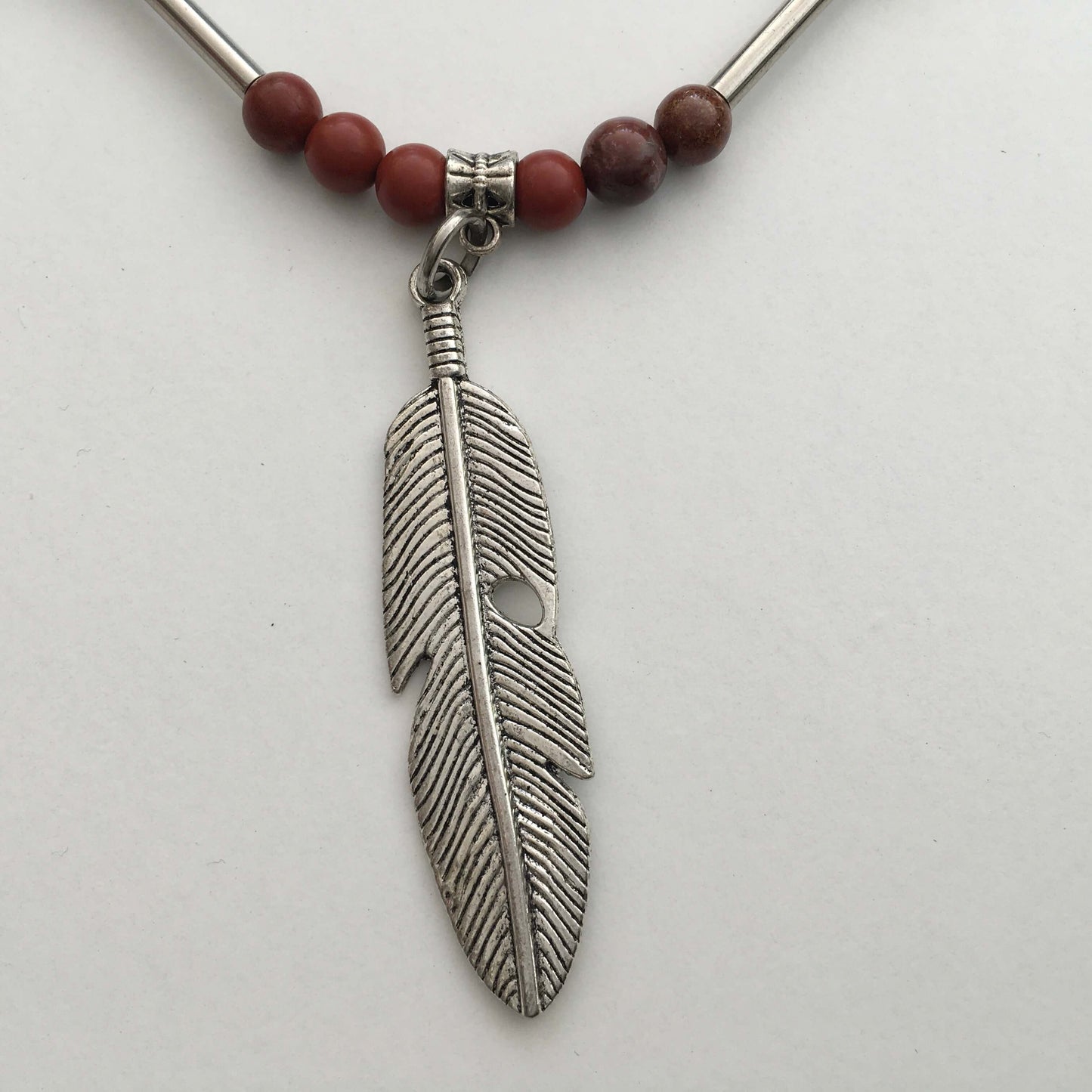 Detail of the silver finish feather pendant