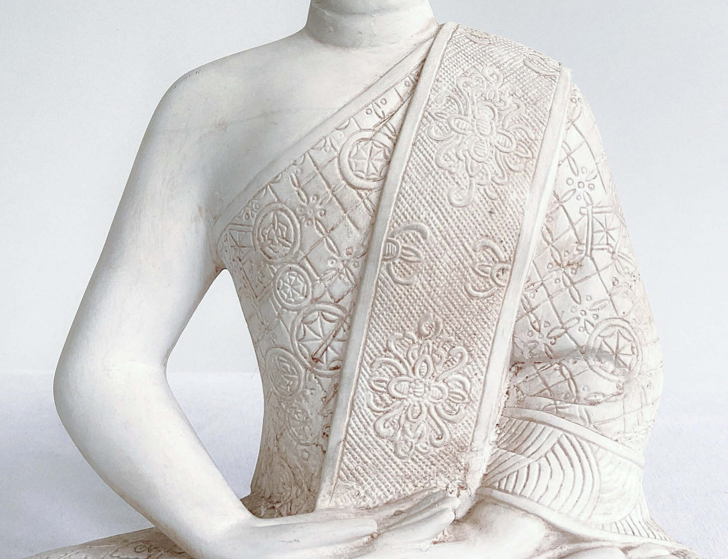 Close up view of buddha robes, natural off white coloring.