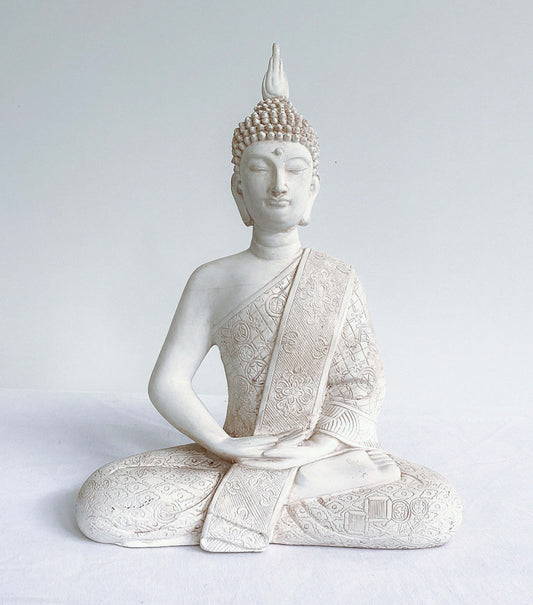 Front view of buddha in lotus position, natural off white coloring, ornate robes, with ushnisha on head.
