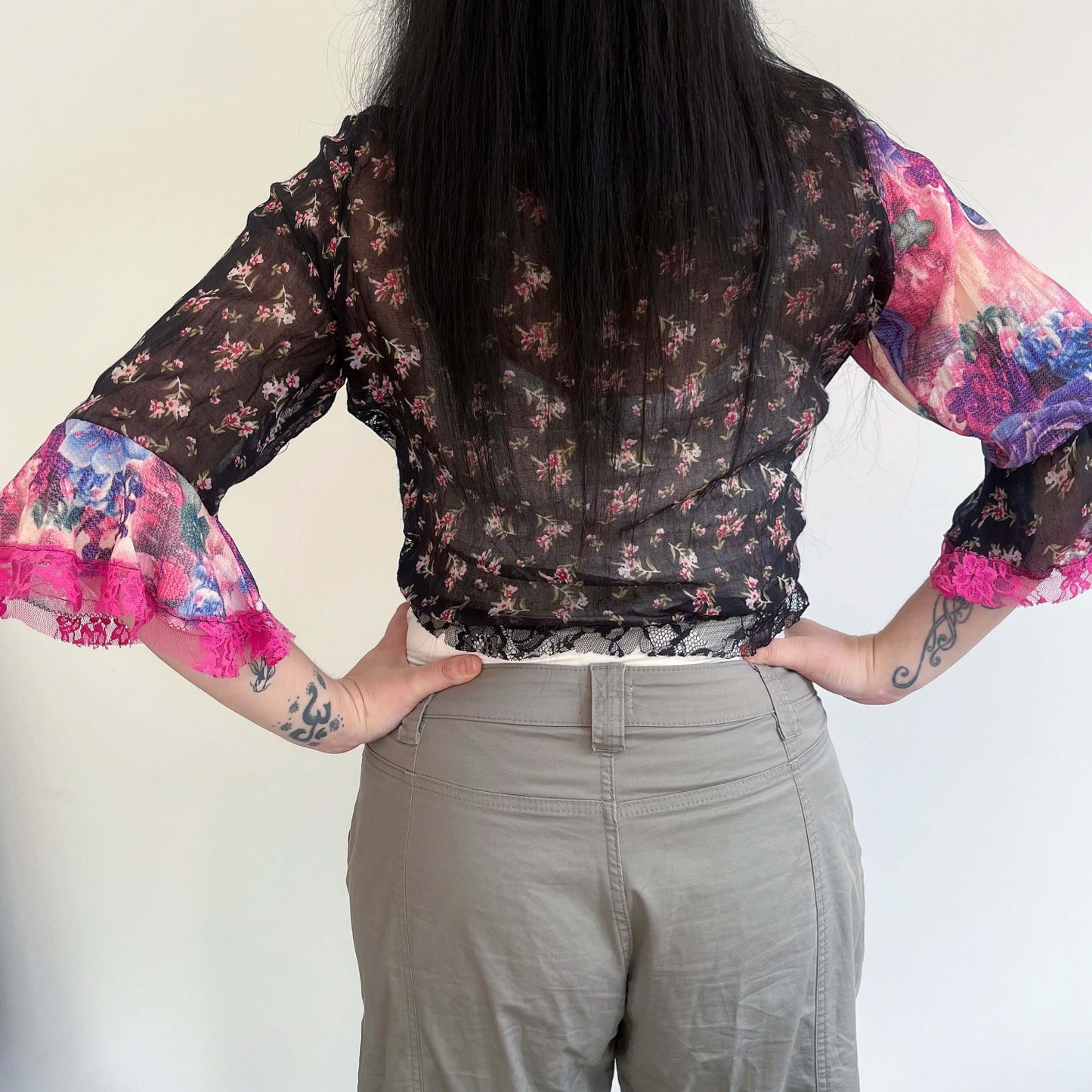 Back view of tie top, printed cotton black, with small pinkish flowers.