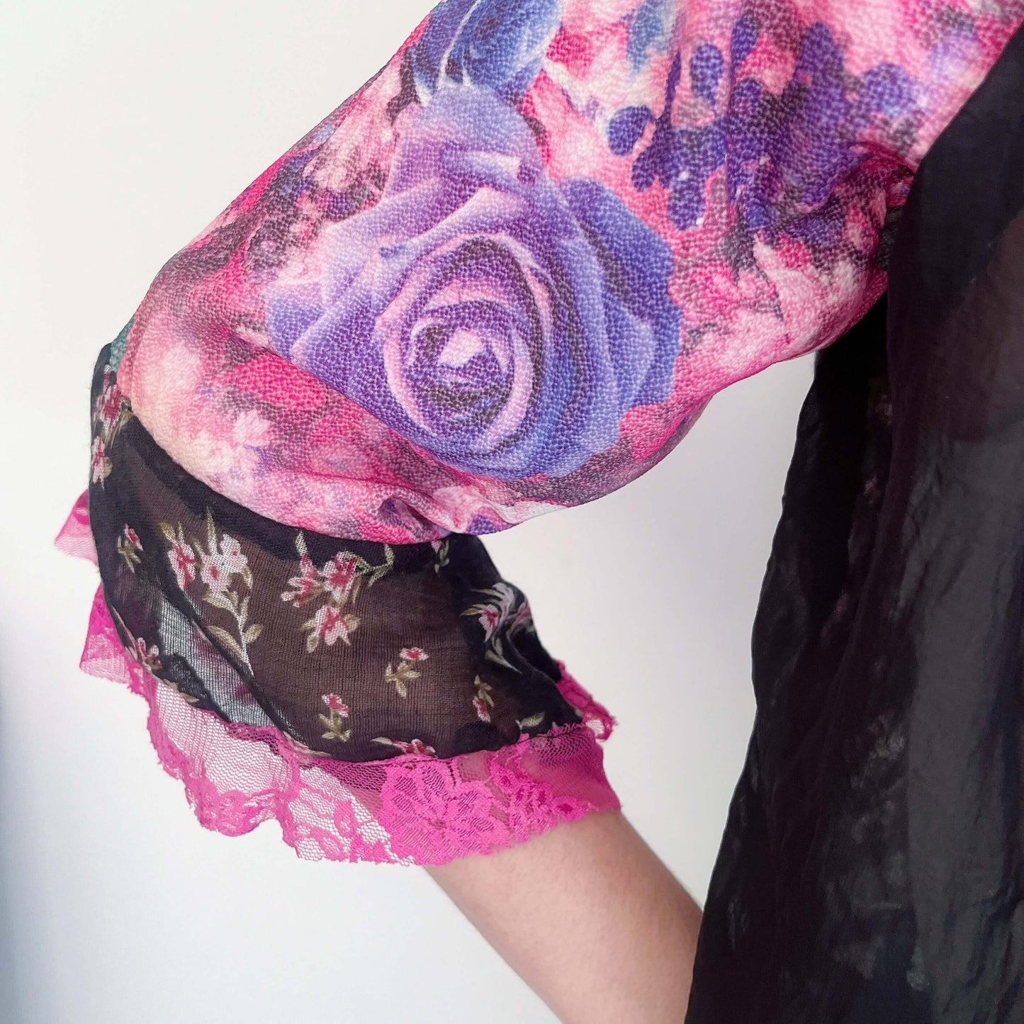 Front detail of right side, with black chiffon front, and printed georgette pink sleeve, black lace edging.