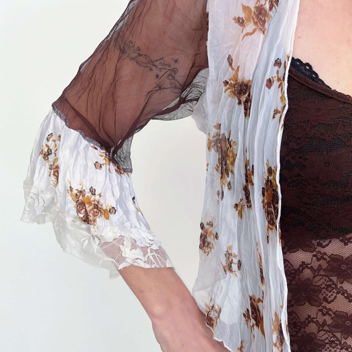 Detail view floral chiffon on left, with brown chiffon sleeve, and floral printed satin sleeve frill. 