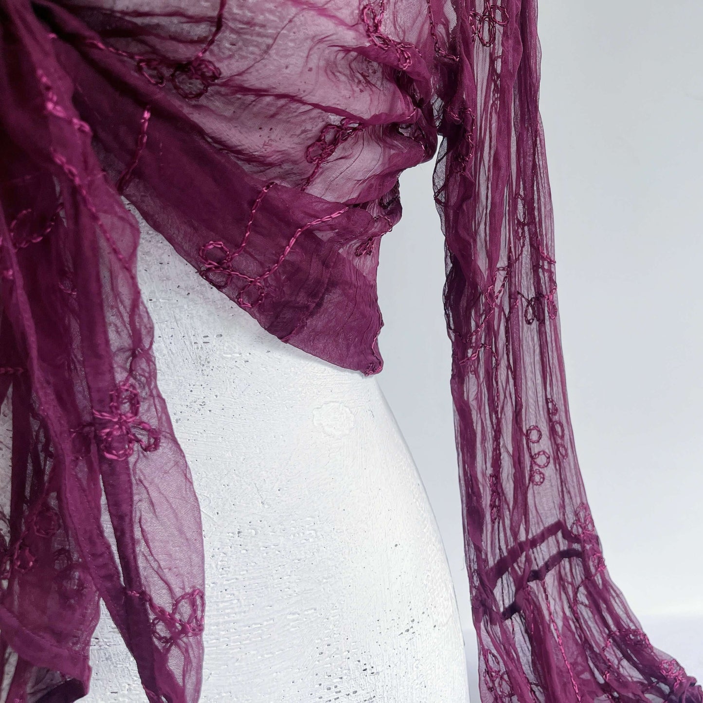 Close up view of embroidered chiffon tie top, showing the soft fabric and embroidery.