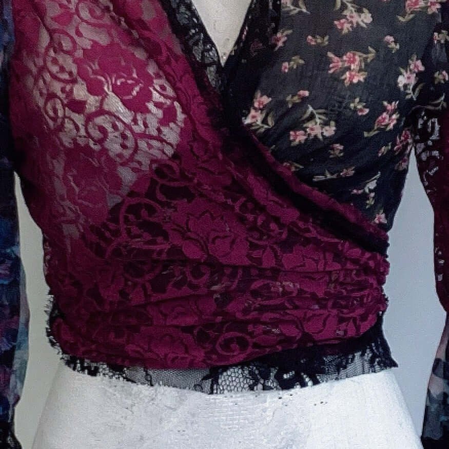 Detail view of tie top, plum lace on the left, crossing over floral cotton on the right. 