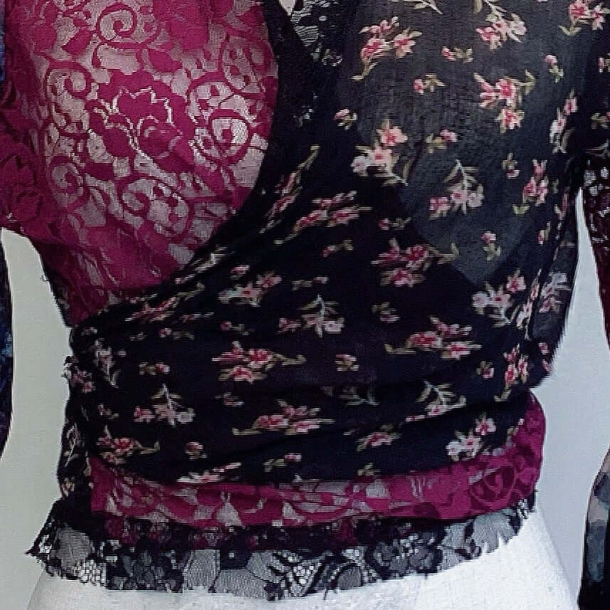 Detail view of tie top, floral cotton on the right, crossing over plum lace on the left.