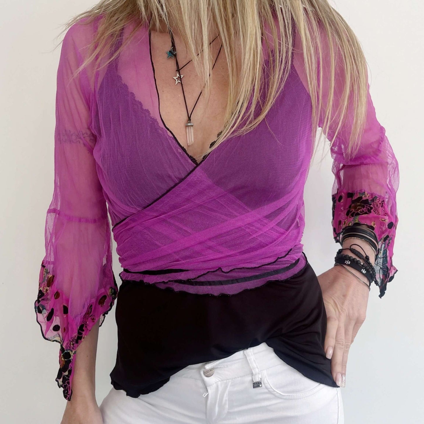Front view of fuchsia net tie top, crossed over in front, tied at the back.