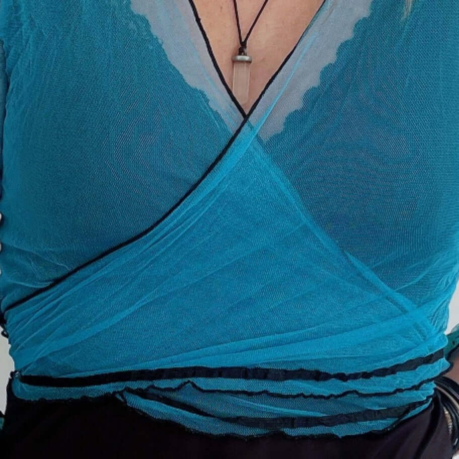 Detail view of turquoise net tie top, crossed over and tied at the back.