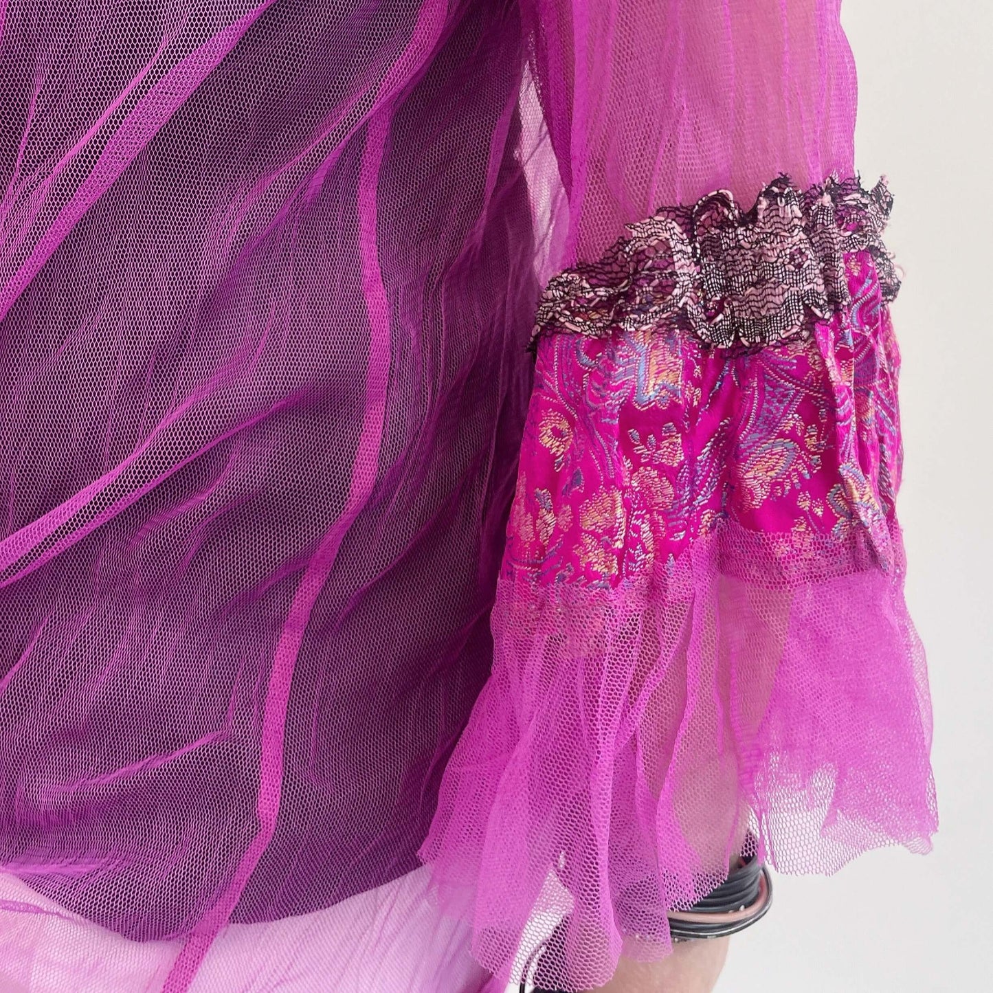 Detail view of sleeve cuff showing the silk brocade and lace at the edges.