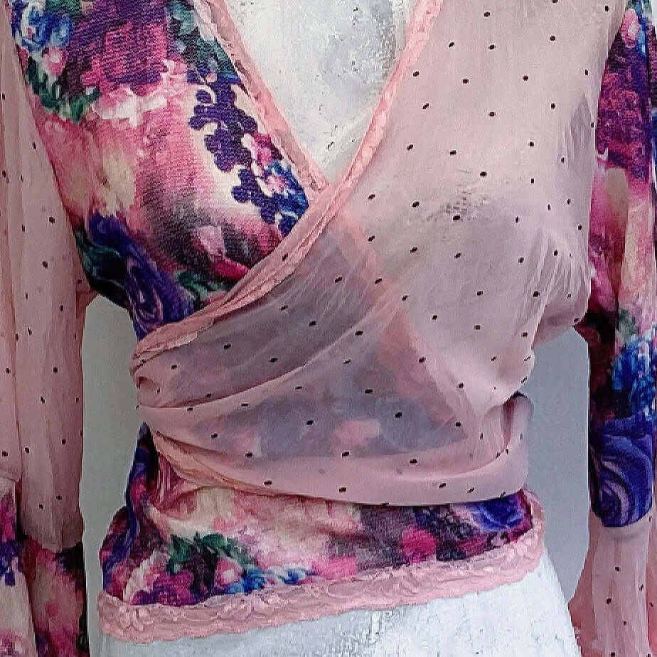 Detail front view, crossover of pale pink chiffon with black dot, over floral georgette, top is tied at the back.