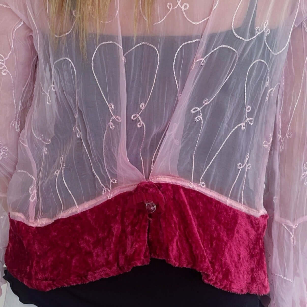 Back view of tie top with cerise viscose velvet trim on hem, with small pleat.