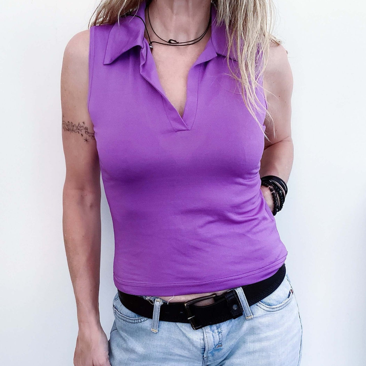 Front view sleeveless stretch fabric top, v neck with same fabric collar.