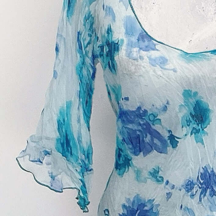 Detail view of chiffon top, showing the three quarter sleeve with frill.