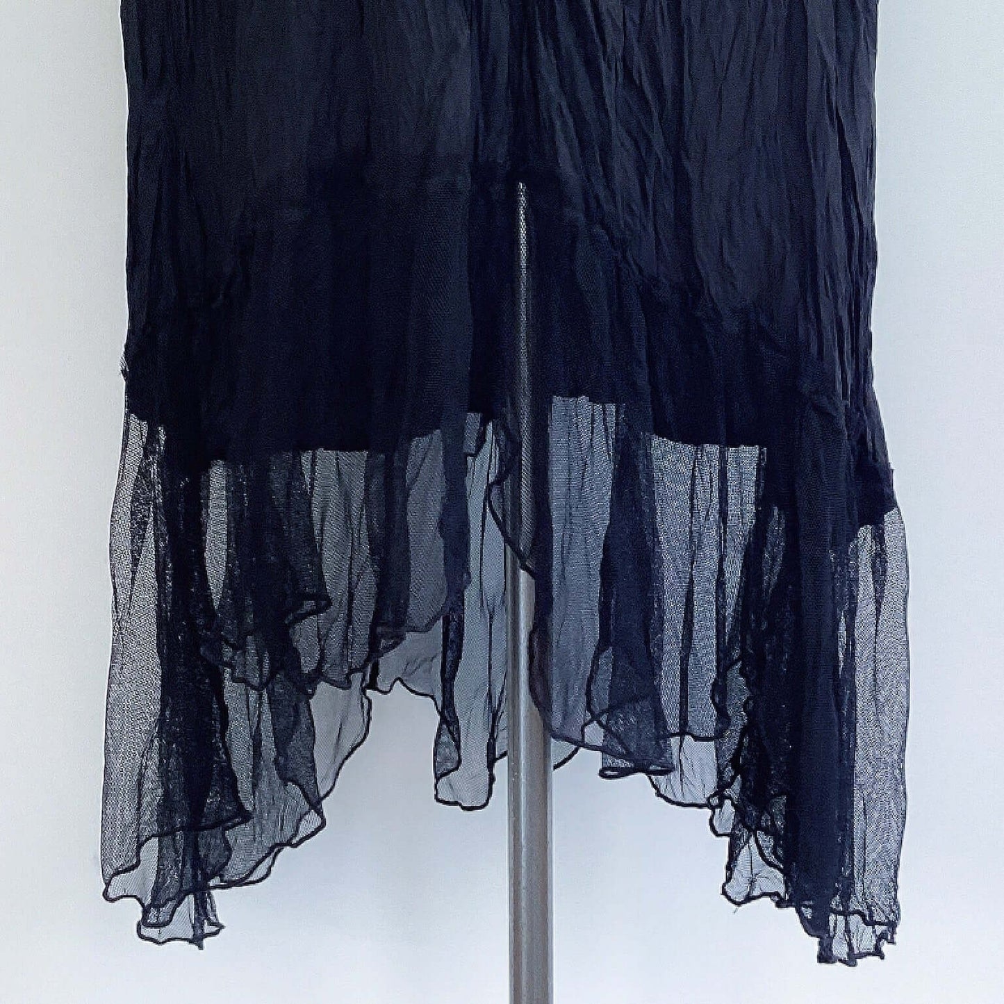 View of hemline of zingara dress, showing gathered mesh frill that rises slightly n the front and the back.