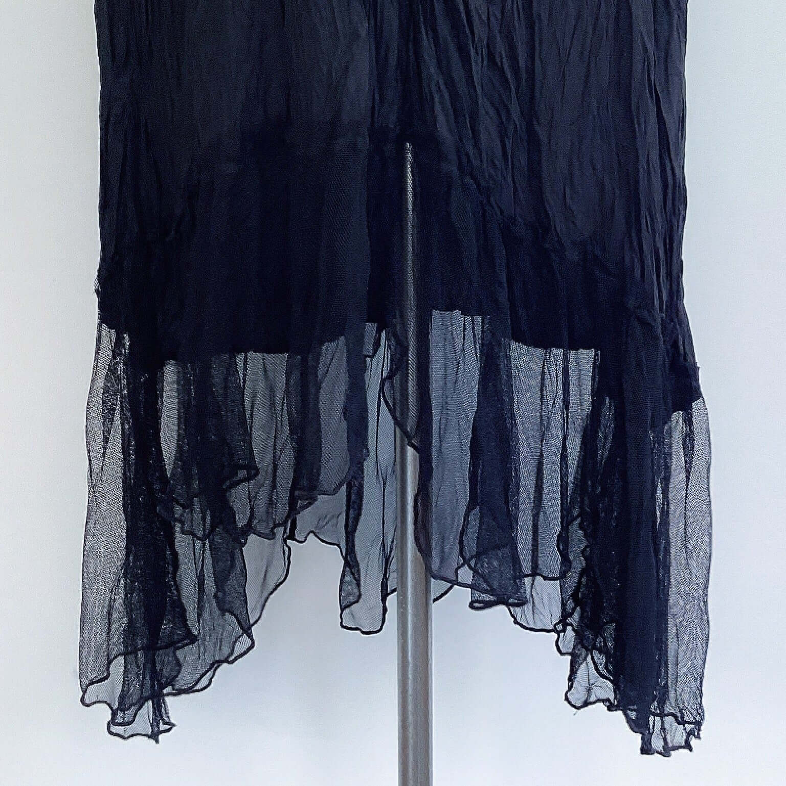 View of hemline of zingara dress, showing gathered mesh frill that rises slightly n the front and the back.