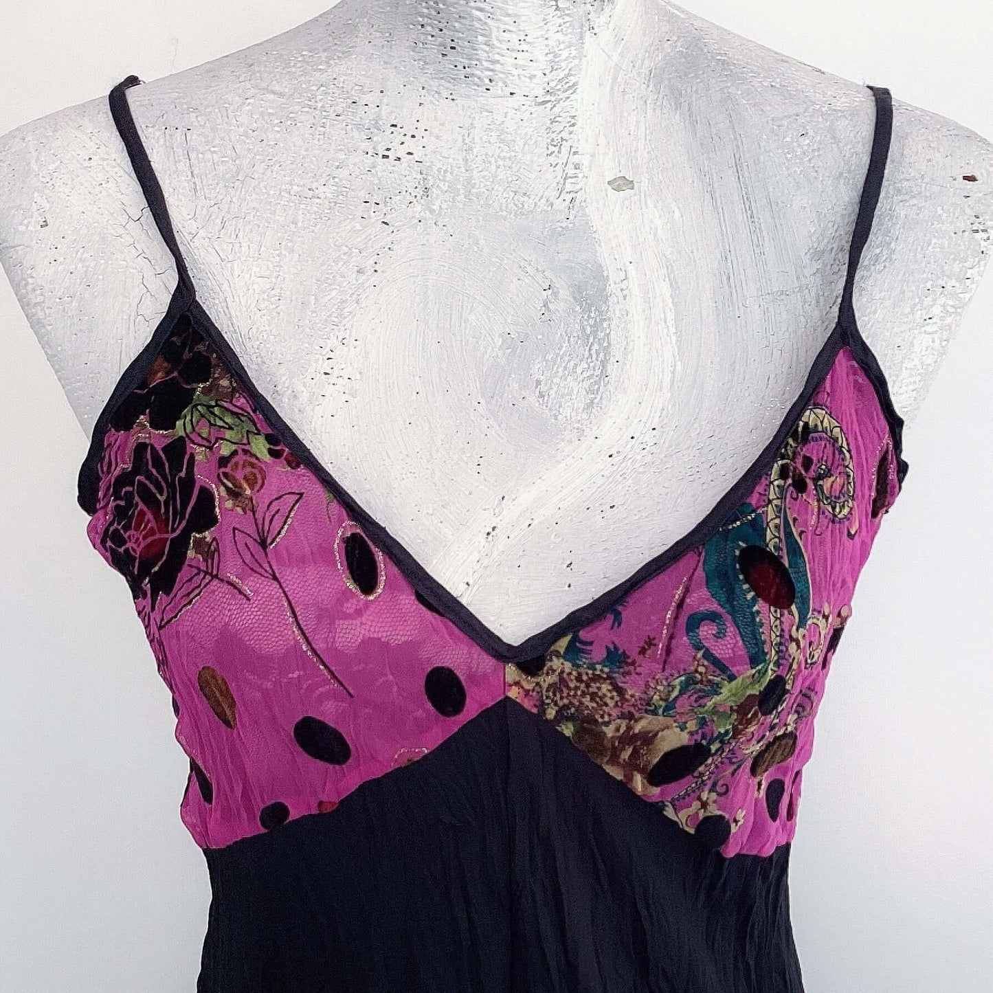 Detail view of zingara bodice area, black velvety embossed roses and dots on pink chiffon backing.