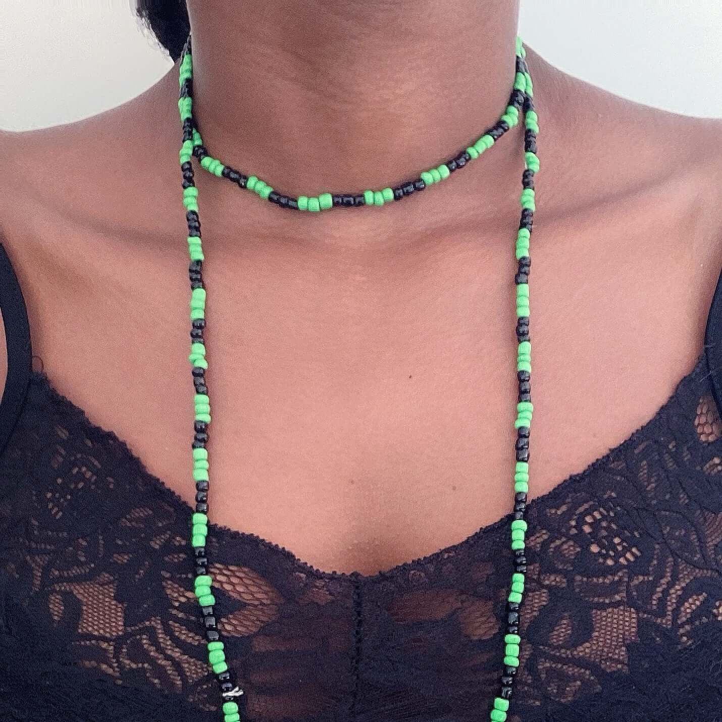 Zulu necklace worn doubled around the neck, with alternating black and green beads, approximately 3mm beads.