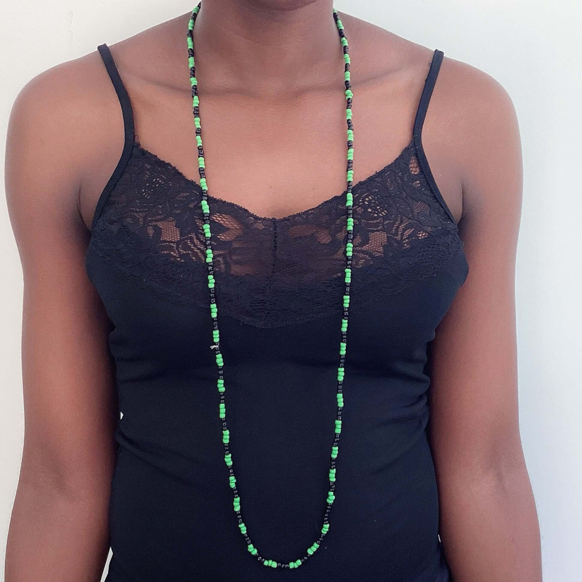 Zulu necklace worn long in a single strand, with alternating black and green beads, approximately 3mm beads.